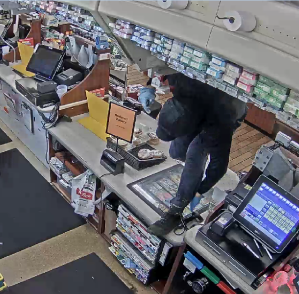 Suspect climbs over counter